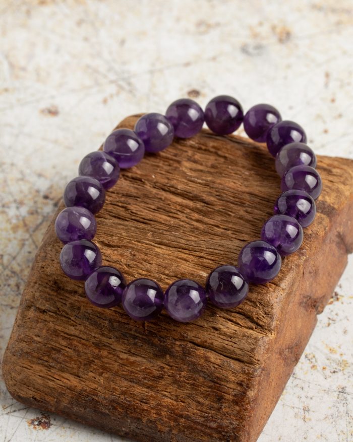 Handmade stone bracelets featuring amethyst, citrine, rose quartz, garnet, and hematite stones, symbolizing natural beauty and healing.