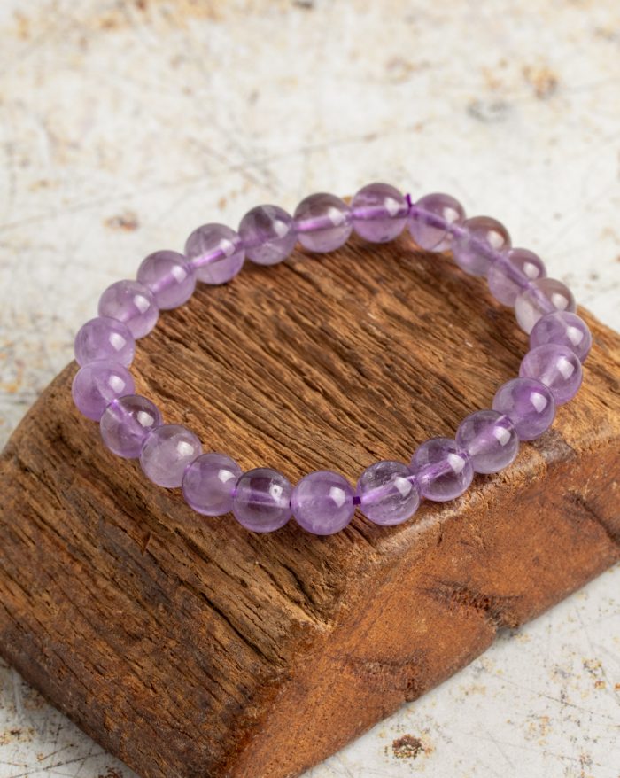 Handmade stone bracelets featuring amethyst, citrine, rose quartz, garnet, and hematite stones, symbolizing natural beauty and healing.