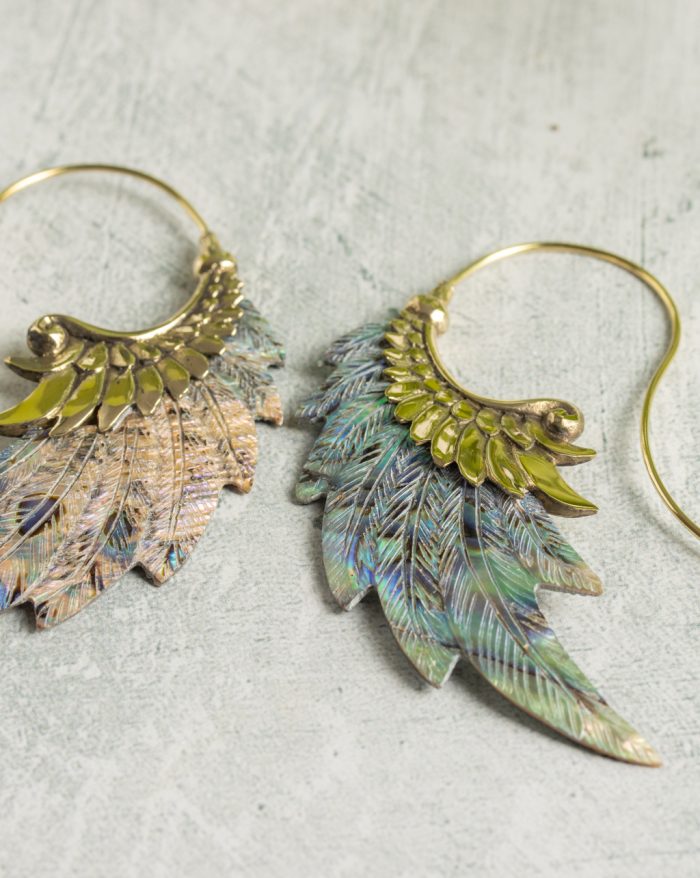 Hand-carved gold-plated feather earrings from the Bali collection with abalone shell accents, handmade with native craftsmanship.