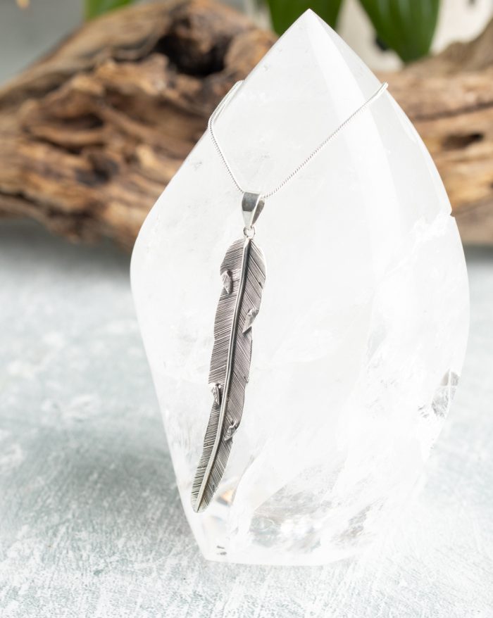 Handmade silver feather pendant with fine details, inspired by Bali's native artistry and crafted by artisans.