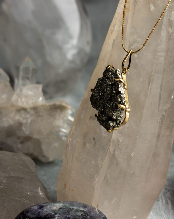 "Handmade gold-plated pendant with raw crystal gemstone in unique shapes, perfect as a birthstone piece.