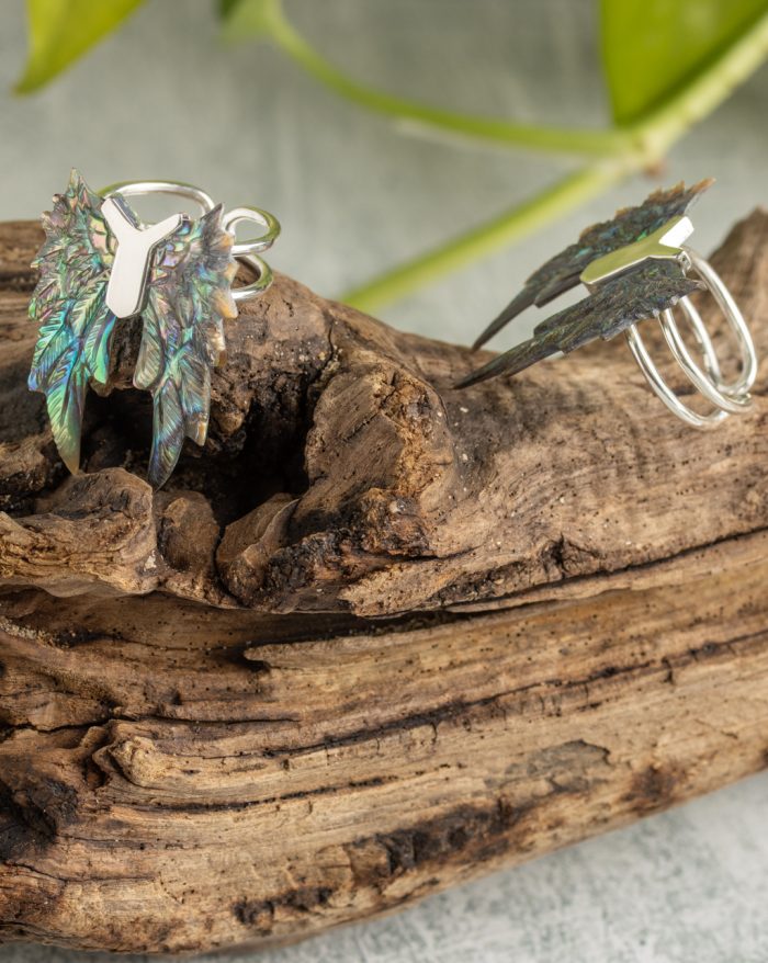 Hand-carved silver feather ring from the Bali collection, available in abalone and bone versions, showcasing native craftsmanship.