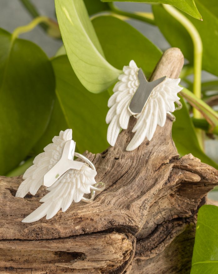 Hand-carved silver feather ring from the Bali collection, available in abalone and bone versions, showcasing native craftsmanship. Adjustable