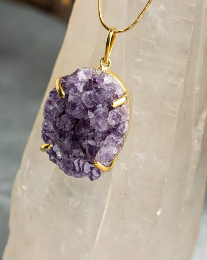 "Handmade gold-plated pendant with raw crystal gemstone in unique shapes, perfect as a birthstone piece.