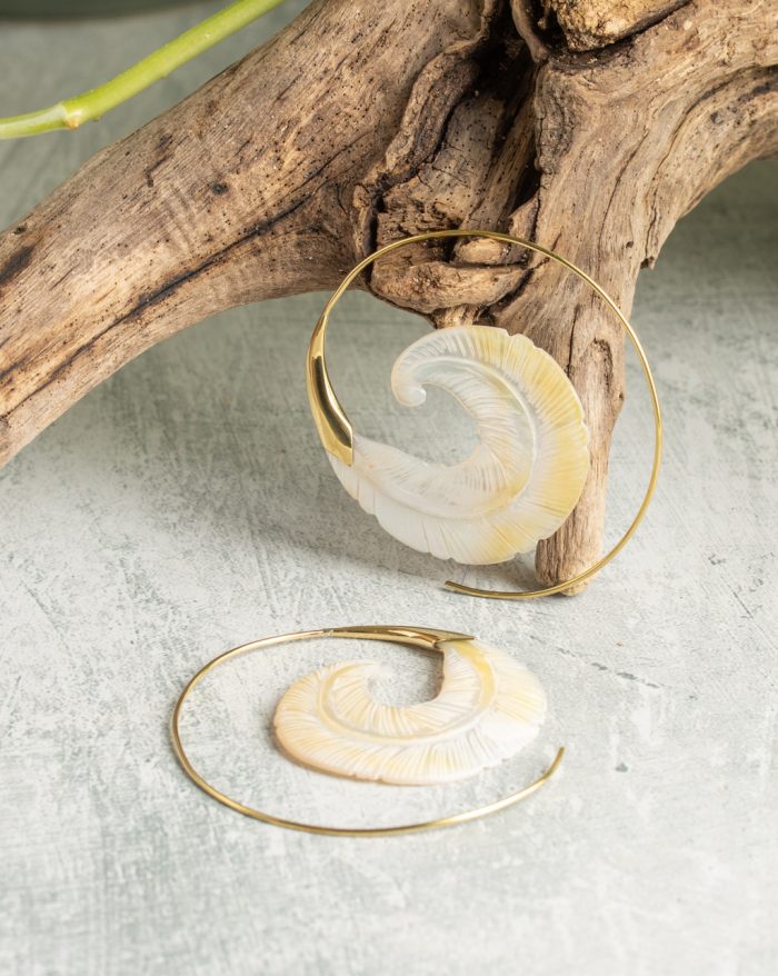 Hand-carved gold-plated feather earrings from the Bali collection, featuring bone and shell details, artisan handmade.