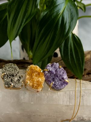 "Handmade gold-plated pendant with raw crystal gemstone in unique shapes, perfect as a birthstone piece.