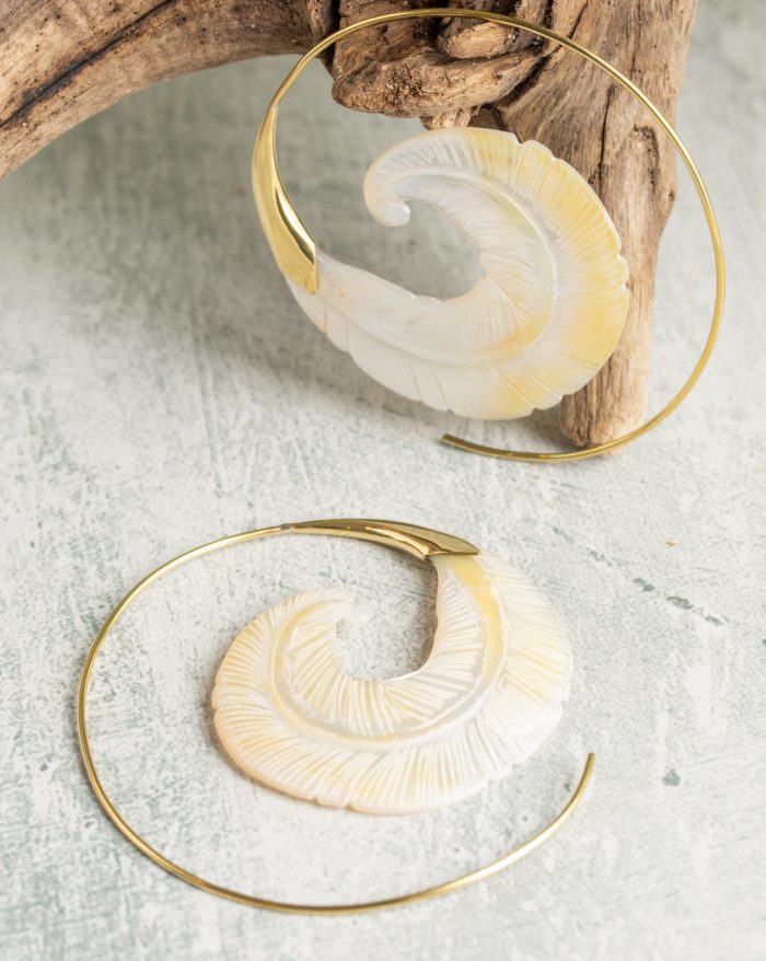 Hand-carved gold-plated feather earrings from the Bali collection, featuring bone and shell details, artisan handmade.