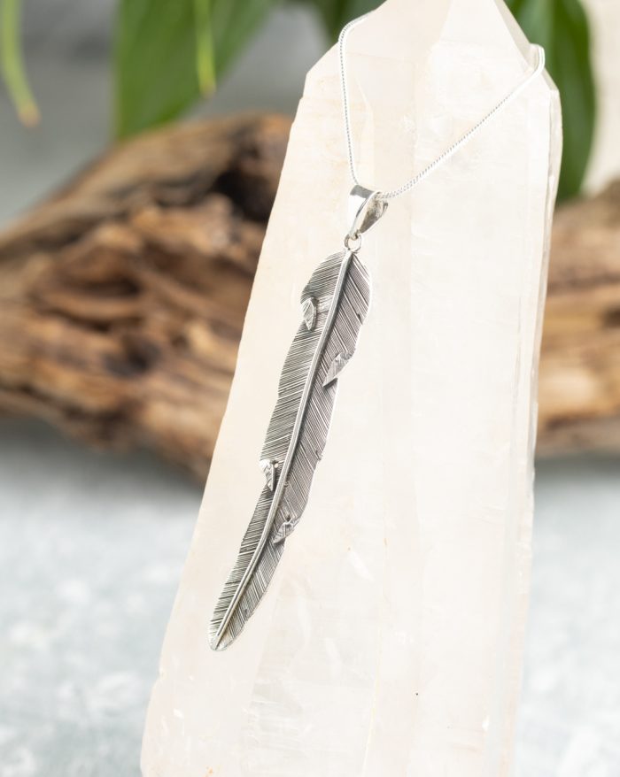 Handmade silver feather pendant with fine details, inspired by Bali's native artistry and crafted by artisans.