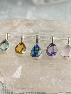 Handmade teardrop-shaped silver pendant featuring a gemstone from Brazil, perfect as a birthstone and fine artisan jewellery.