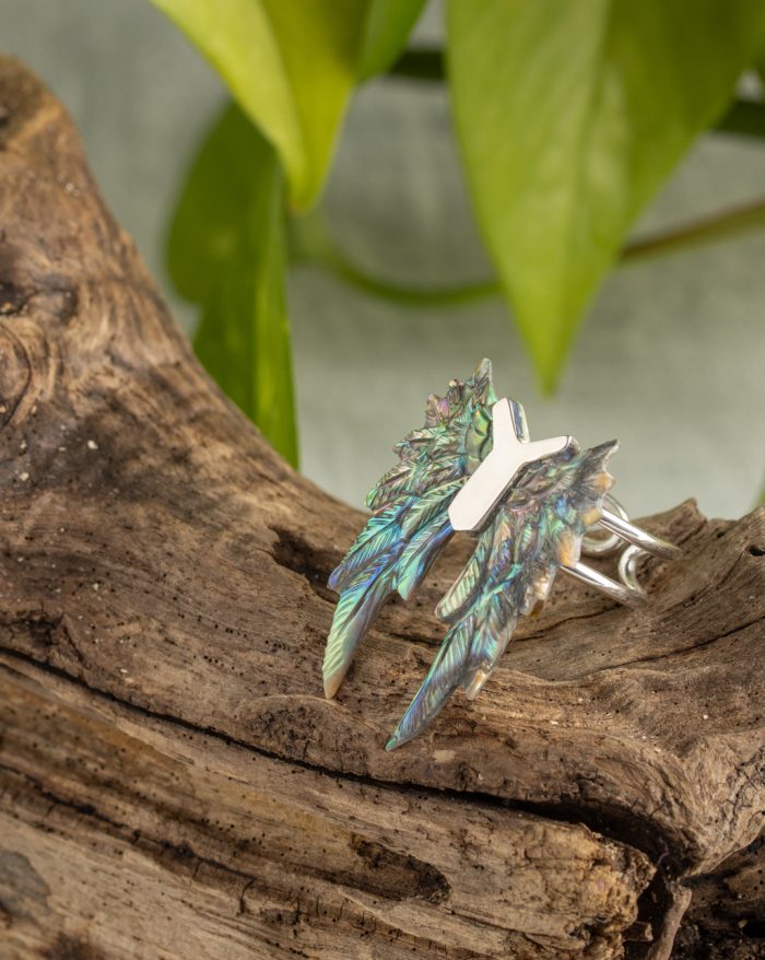 Hand-carved silver feather ring from the Bali collection, available in abalone and bone versions, showcasing native craftsmanship.