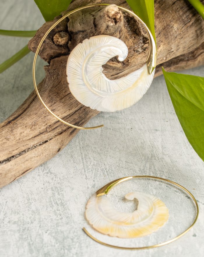 Hand-carved gold-plated feather earrings from the Bali collection, featuring bone and shell details, artisan handmade.