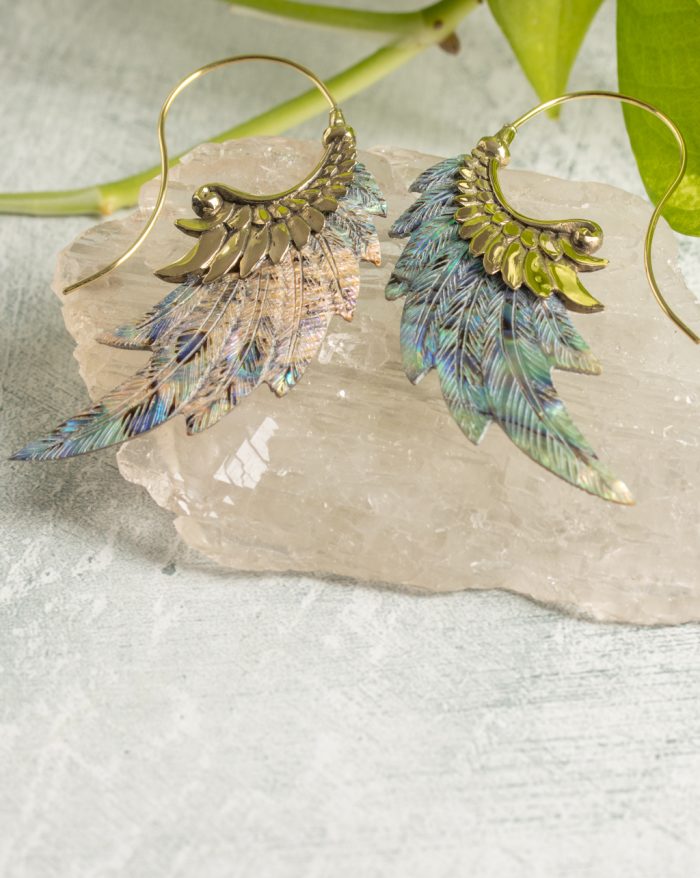 Hand-carved gold-plated feather earrings from the Bali collection with abalone shell accents, handmade with native craftsmanship.