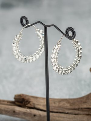 Handmade large silver hoop earrings with symmetrical design, inspired by Bali's native artistry.