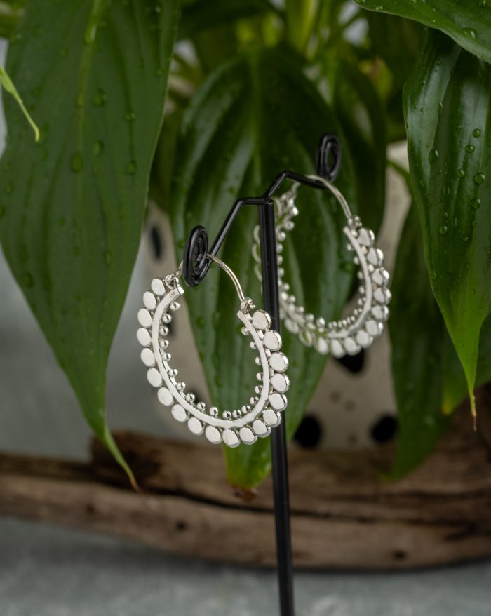 Handmade large silver hoop earrings with symmetrical design, inspired by Bali's native artistry.