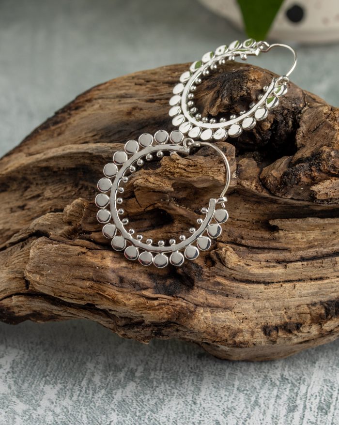 Handmade large silver hoop earrings with symmetrical design, inspired by Bali's native artistry.