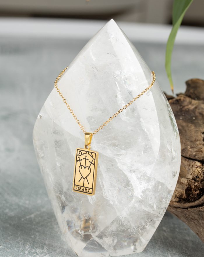 Gold-plated esoteric pendant with symbolic designs, paired with a matching chain, representing deep meaning and spirituality.