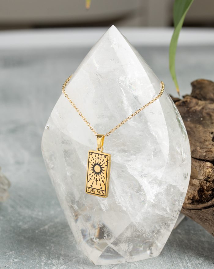 Gold-plated esoteric pendant with symbolic designs, paired with a matching chain, representing deep meaning and spirituality.