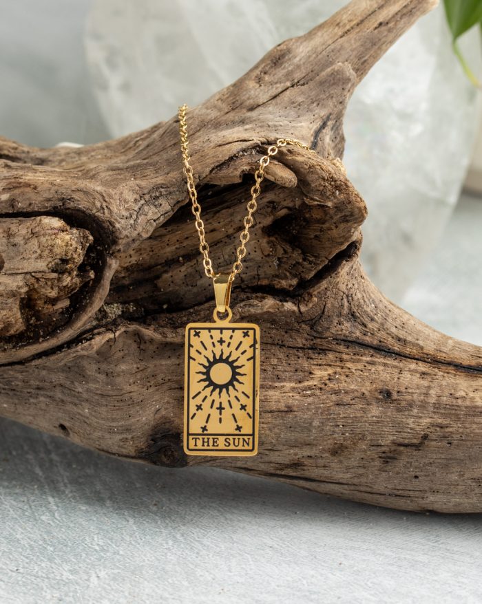 Gold-plated esoteric pendant with symbolic designs, paired with a matching chain, representing deep meaning and spirituality.