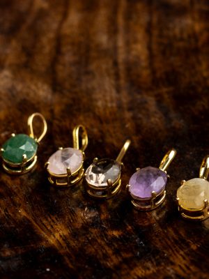 Handmade gold-plated pendant with round gemstones, symbolizing beauty and healing power, crafted with artisan care.