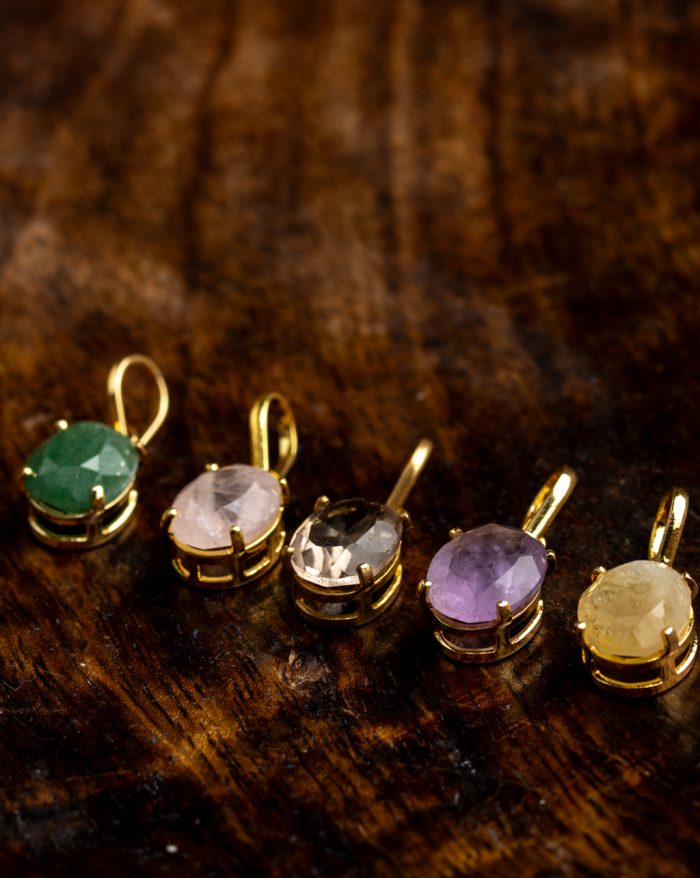 Handmade gold-plated pendant with round gemstones, symbolizing beauty and healing power, crafted with artisan care.