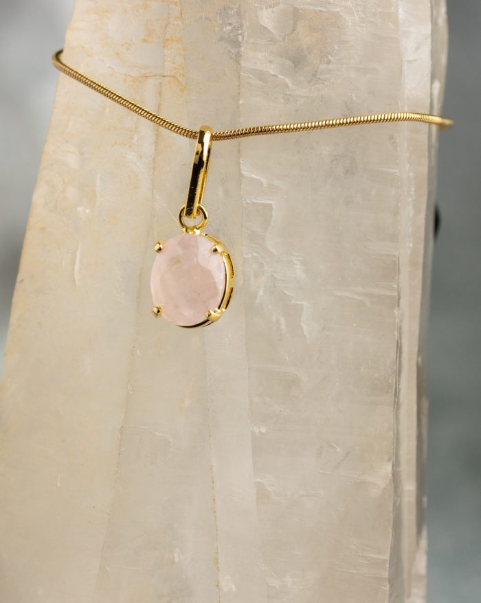 Handmade gold-plated pendant with round gemstones, symbolizing beauty and healing power, crafted with artisan care.