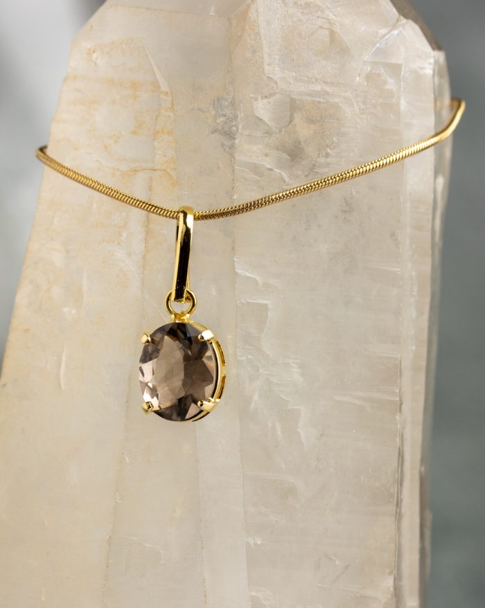 Handmade gold-plated pendant with round gemstones, symbolizing beauty and healing power, crafted with artisan care.