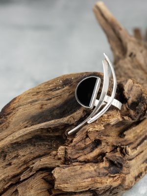 Handmade silver ring from the Brasil Collection featuring a black stone with long curves and half-moon and half-circle symbolic shapes.