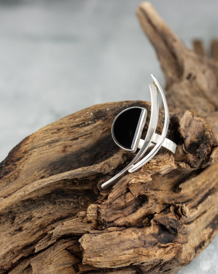 Handmade silver ring from the Brasil Collection featuring a black stone with long curves and half-moon and half-circle symbolic shapes.