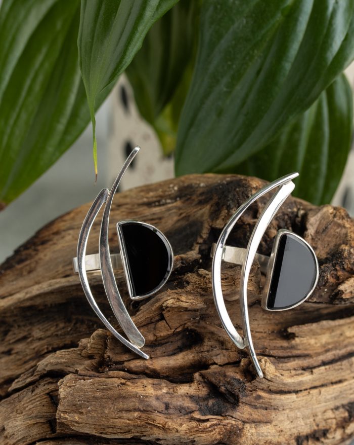 Handmade silver ring from the Brasil Collection featuring a black stone with long curves and half-moon and half-circle symbolic shapes.