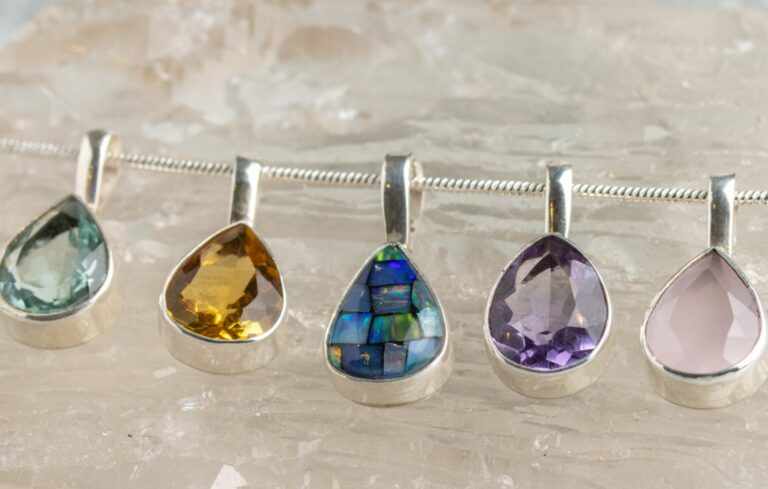 Five teardrop silver pendants set with green, citrine, opal, amethyst and rose quartz stones