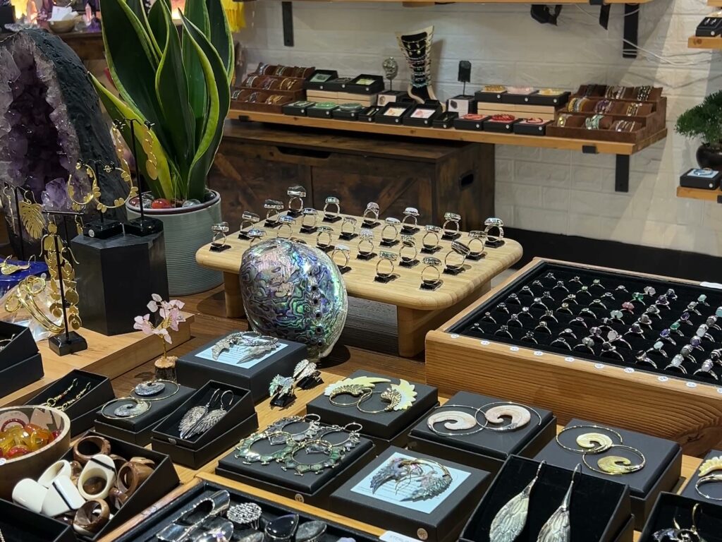 Ring trays, an abalone shell and an amethyst geode on the wooden displays inside the High Barnet shop